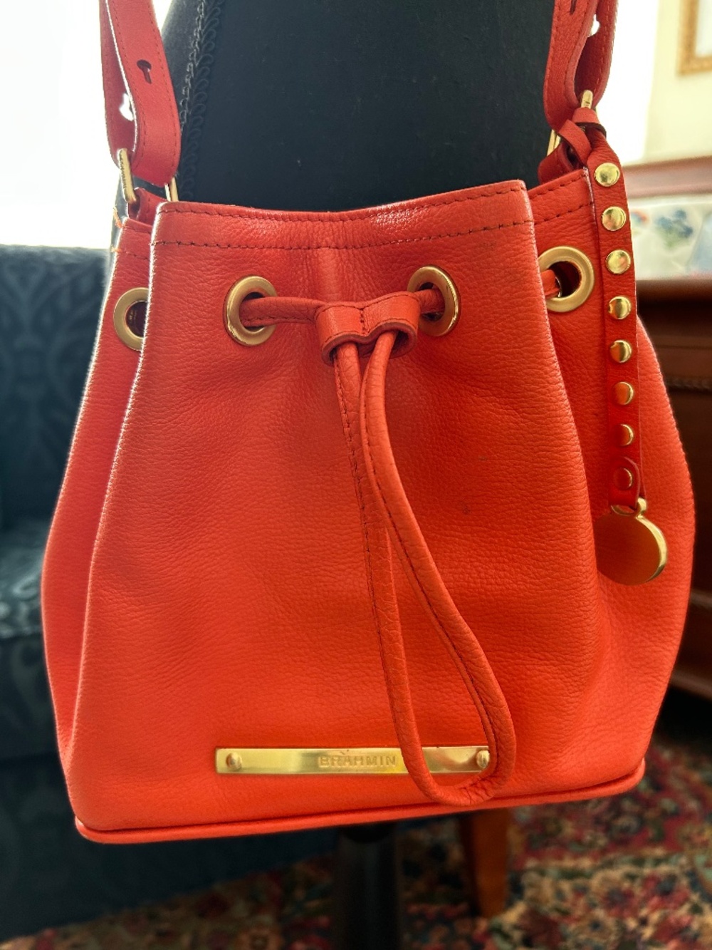 Brahmin orange leather adjustable crossbody bag.